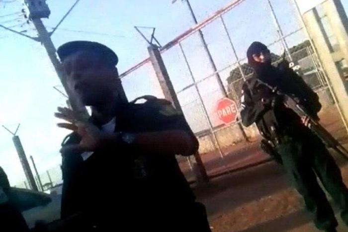 Video grab taken from Folha de Boa Vista shows police officers standing guard as relatives of inmates gather outside the Agricola de Monte Cristo prison in Boa Vista, in the Brazilian northern state of Roraima, on October 16, 2016