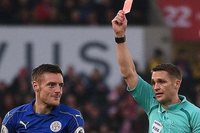 English referee Craig Pawson (R) shows a red card to Leicester City's striker Jamie Vardy for his challenge on Stoke City's striker Mame Biram Diouf during the English Premier League football match between Stoke City and Leicester City