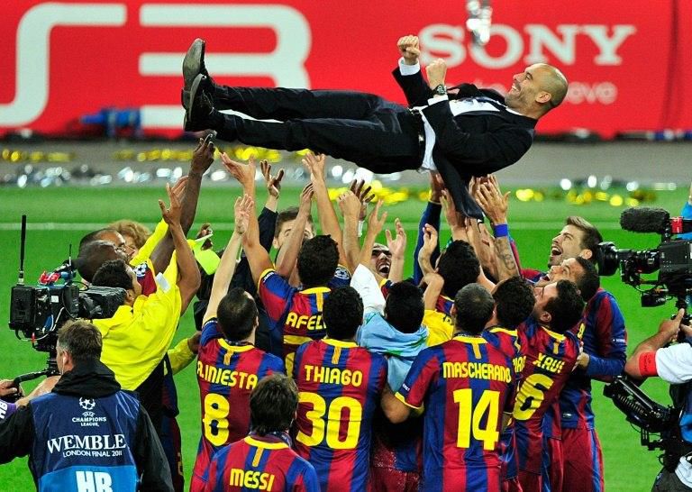 Pep Guardiola is thrown into the air by Barcelona players after winning the Champions League in 2011