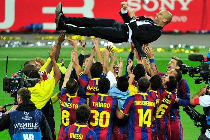 Pep Guardiola is thrown into the air by Barcelona players after winning the Champions League in 2011