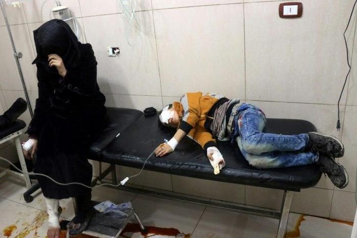 Wounded Syrians are seen on a table in a crowded makeshift hospital in eastern Aleppo on November 18, 2016