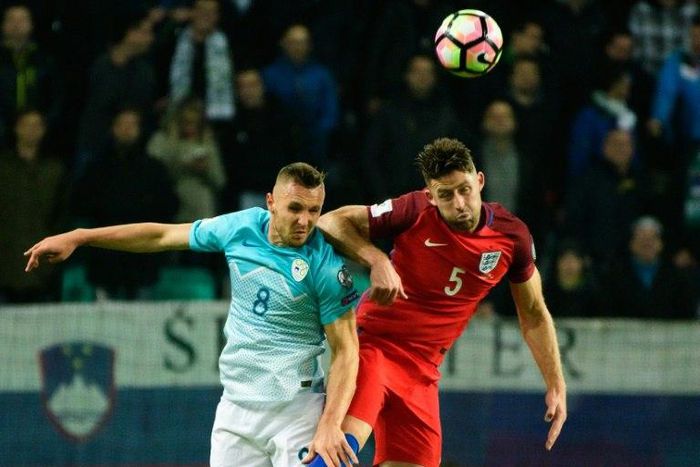 Slovenia's midfielder Jasmin Kurtic (L) vies for the ball with England's defender Gary Cahill (R) during the Fifa World Cup 2018 football qualification match between Slovenia and England on October 11, 2016