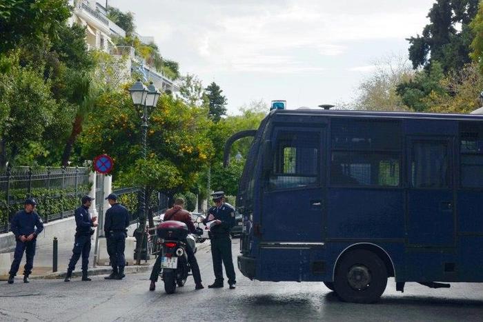 Police check the identity of a man near the prime minister's and president's offices in Athens on November 14, 2016 as part of the security measures set ahead of the visit of outgoing US president Barack Obama