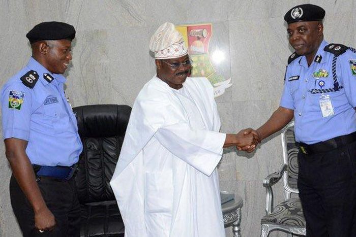 Oyo state gov, Abiola Ajimobi with the police commissioner Oyo State Command, Samuel Adegbuyi and the former police commissioner, Leye Oyebade