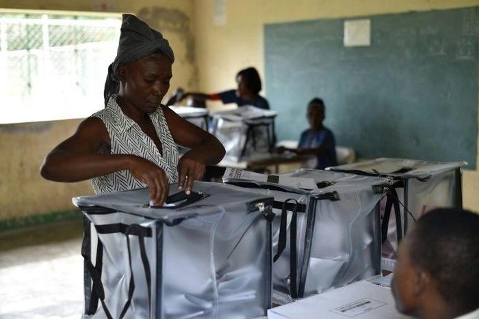 A voter casts her ballot at a polling station in a school in the commune of Cite Soleil, in the Haitian capital Port-au-Prince, on November 20, 2016