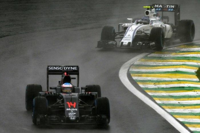 McLaren-Honda's driver Fernando Alonso (front) powers his car during the Brazilian Grand Prix at the Interlagos circuit in Sao Paulo, Brazil, on November 13, 2016