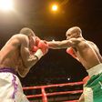 Richard Amefu in white shorts slugging it out with Joe Boy in Green and white shorts