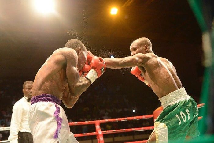 Richard Amefu in white shorts slugging it out with Joe Boy in Green and white shorts