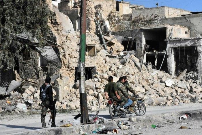 Syrian pro-government forces patrol the Bab al-Hadid neighbourhood in Aleppo's Old City, after taking control of the area from rebels