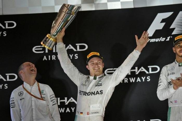 Mercedes AMG Petronas F1 Team's driver Nico Rosberg (C) celebrates at the end of the Abu Dhabi Formula One Grand Prix at the Yas Marina circuit on November 27, 2016