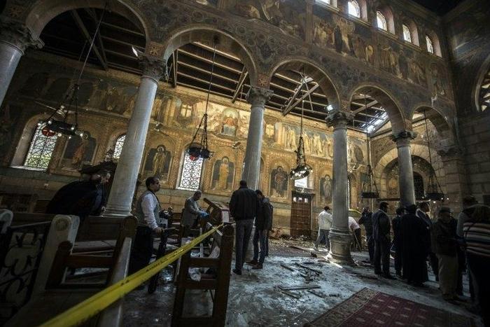 Egyptian security forces inspect the scene of a bomb explosion at the Saint Peter and Saint Paul Coptic Orthodox Church in Cairo on December 11, 2016