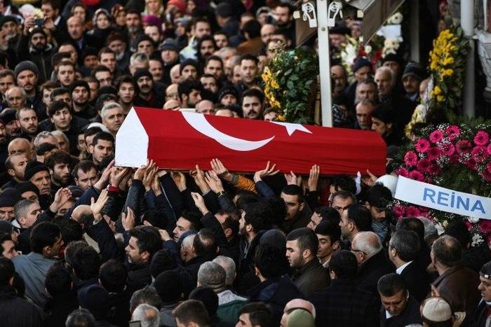 People carry the coffin of Yunus Gormek, 23, one of the victims of the Reina night club attack, during his funeral ceremony on January 2, 2017 in Istanbul