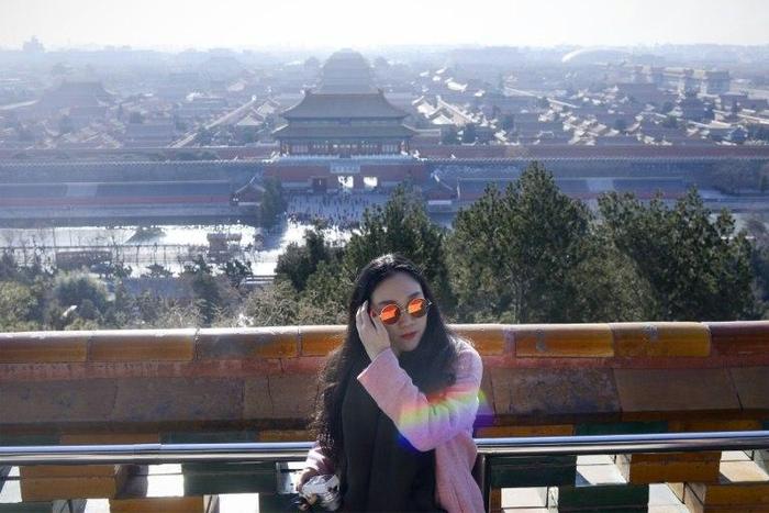 A woman visits a park near the Forbidden City in Beijing on December 22, 2016
