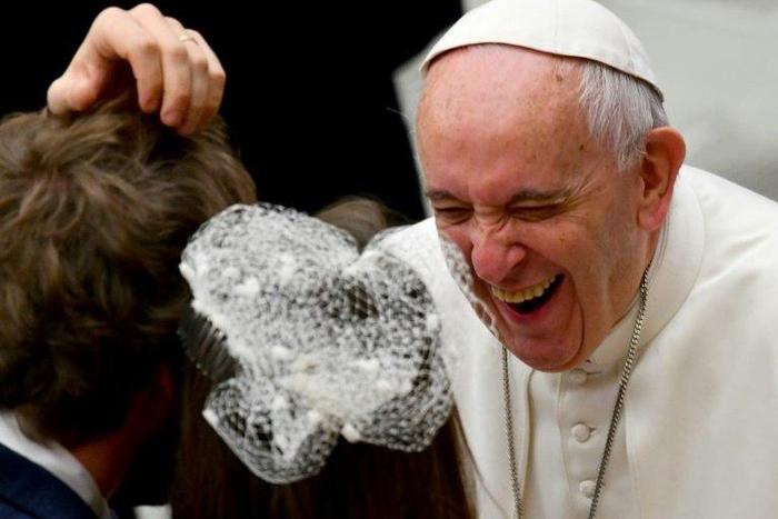 Pope Francis laughs as he greets people during his weekly general audience at the Paul VI audience Hall on December 7, 2016 in Vatican