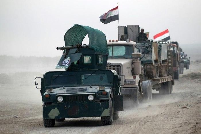 Shiite fighters drive their vehicles towards the village of Umm Sijan, south of Mosul, on October 31, 2016 during Iraqi forces' operation to recapture the main hub city from the Islamic State