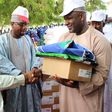 Governor Aminu Waziri Tambuwal, assisted by the Sokoto Commissioner of Health, Dr. Balarabe Kakale, presenting mosquito nets and anti-malaria kits to a beneficiary at an event to mark this year's World Malaria Day celebration in Sokoto...Monday 25/04/1...