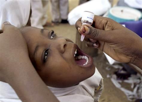 A health worker gives a child an oral polio vaccine in Kano, Nigeria.