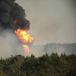 Flames shoot into the sky from a gas line explosion in western Shelby County, Alabama.  