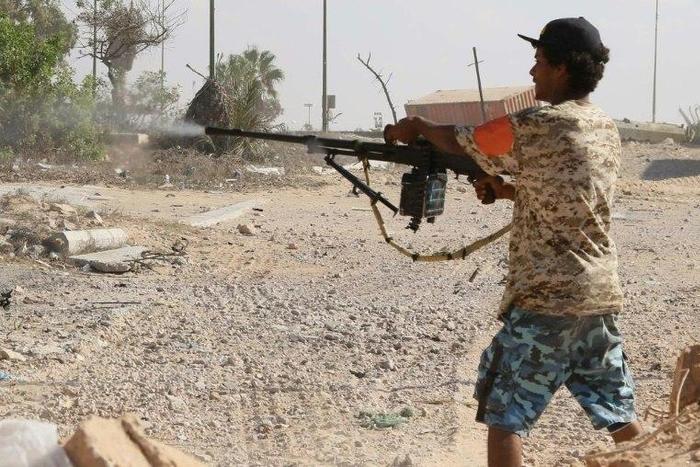 A Libyan pro-regime fighter with the Government of National Accord (GNA) fires at Islamic State jihadists during clashes for control of Sirte, on September 3, 2016