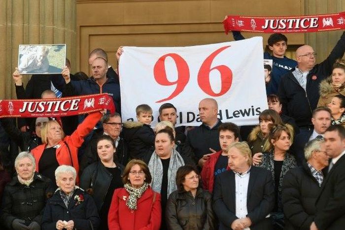 Relatives of the victims of the 1989 Hillsborough disaster gather on the steps of St George's Hall in Liverpool, north west England on April 27, 2016, in remembrance of the 96 Liverpool fans who died in the football stadium disaster