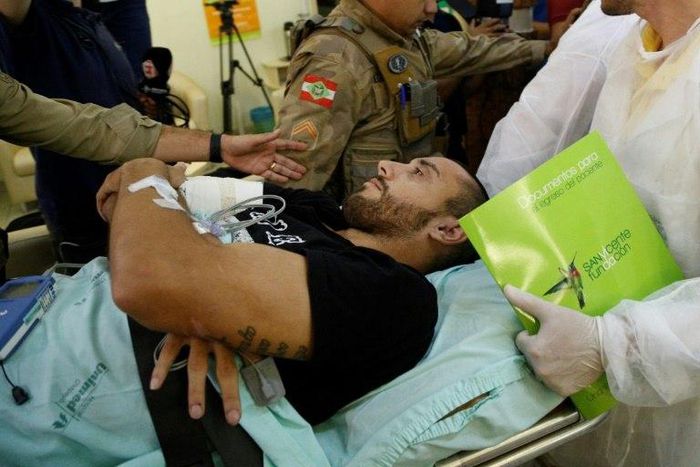 Brazilian Chapecoense footballer Alan Ruschel (C), one of the survivors of the LaMia airliner air crash in Colombia two weeks ago, arrives at hospital in Chapeco, Santa Catarina state, southern Brazil, on December 13, 2016
