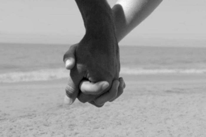 Couple holding hands