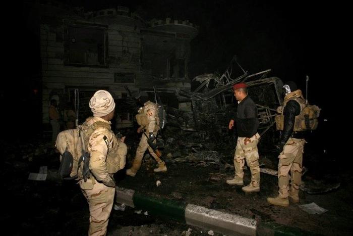 Iraqi forces inspect the scene of a suicide bombing claimed by the Islamic State group that targeted Shiite pilgrims returning from the Arbaeen commemoration in Karbala