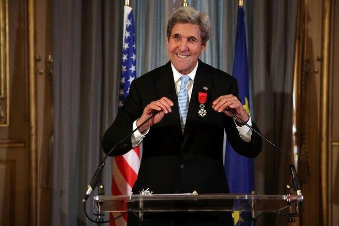 US Secretary of State John Kerry smiles after being awarded the Grand Officier de la Legion d'Honneur (Grand Officer of the Legion of Honor) medal, at the Quai d'Orsay in Paris, on December 10, 2016