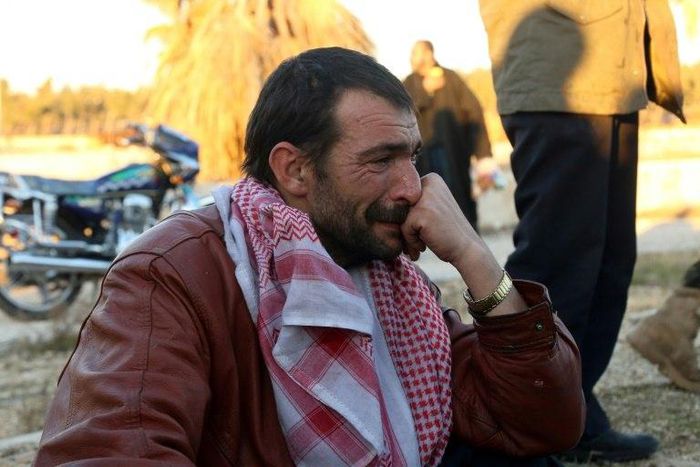 A Syrian evacuated from rebel-held neighbourhoods in Aleppo, cries on arrival at the opposition-controlled Khan al-Aassal region, west of the city