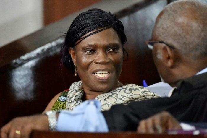 Former Ivorian first lady Simone Gbagbo (L) talks to her lawyer at the Abidjan's courthouse on October 10, 2016 before the re-opening of her trial, during which she was prevented from leaving the courtroom by military police November 29, 2016