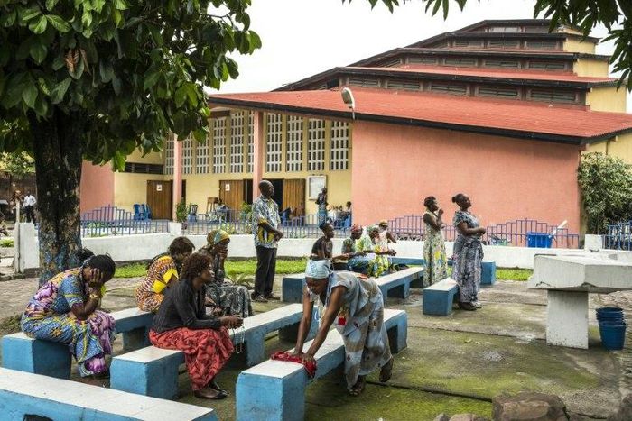 People pray outside the Saint Raphael Parish in Kinshasa, on December 18, 2016