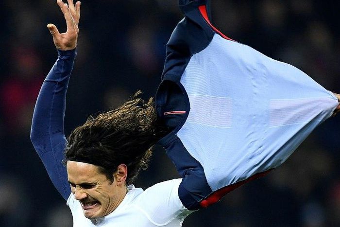 Paris Saint-Germain's Edinson Cavani takes off his jersey as he celebrates his goal against Angers at the Parc des Princes stadium in Paris on November 30, 2016