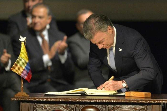 Colombian President Juan Manuel Santos signs the historic peace agreement between the Colombian government and the Revolutionary Armed Forces of Colombia in Bogota, on November 24, 2016
