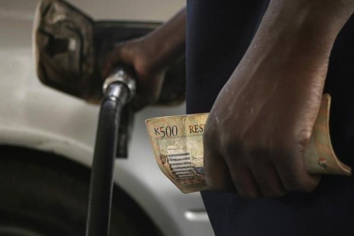 Motorists pumps fuel into his vehicle in the commercial capital Blantyre in this picture taken March 26, 2012. REUTERS/Eldson Chagara