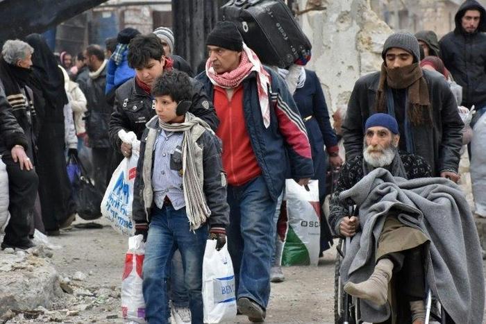 Syrian residents fleeing the eastern part of Aleppo gather in Masaken Hanano, a former rebel-held district which was retaken by the regime forces last week, on November 30, 2016
