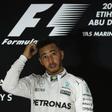 Mercedes AMG Petronas F1 Team's British driver Lewis Hamilton stands on the podium after winning the Abu Dhabi Formula One Grand Prix at the Yas Marina circuit on November 27, 2016
