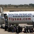 Passengers board a South African Airways Boeing 737 aircraft at the Kamuzu International Airport in Lilongwe October 25, 2009.