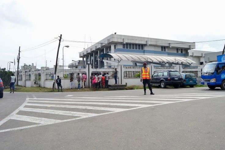 A road safety officer stands in front of a Central Bank of Nigeria building, following an explosion that killed some workers and injured many, in Calabar, Nigeria March 11, 2016.