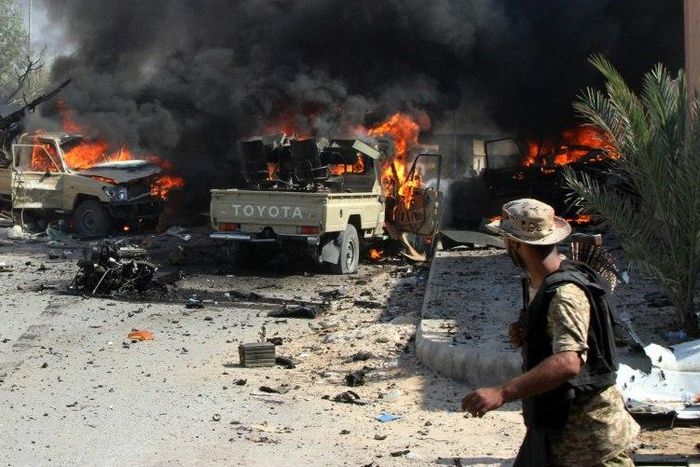 Vehicles of pro-government fighters burn after an IS group suicide bomber detonated explosives nearby on August 16, 2016 