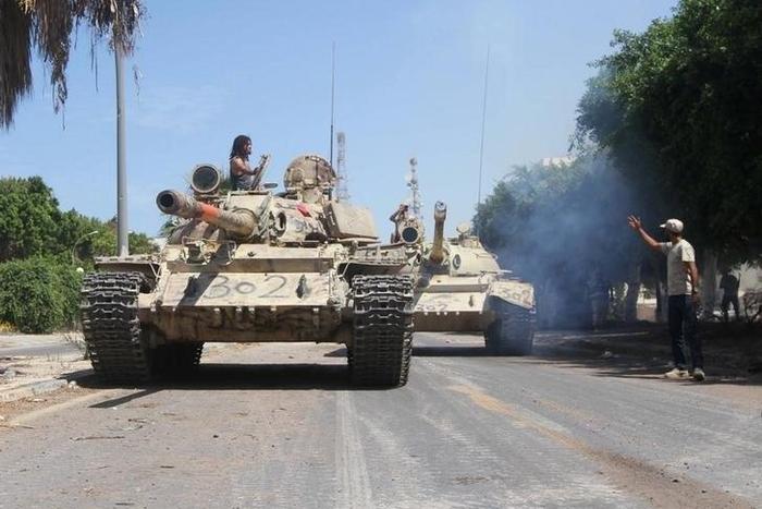 Members of Libyan forces allied with the U.N.-backed ride their tanks during a battle with Islamic State militants in Sirte, Libya September 6, 2016.