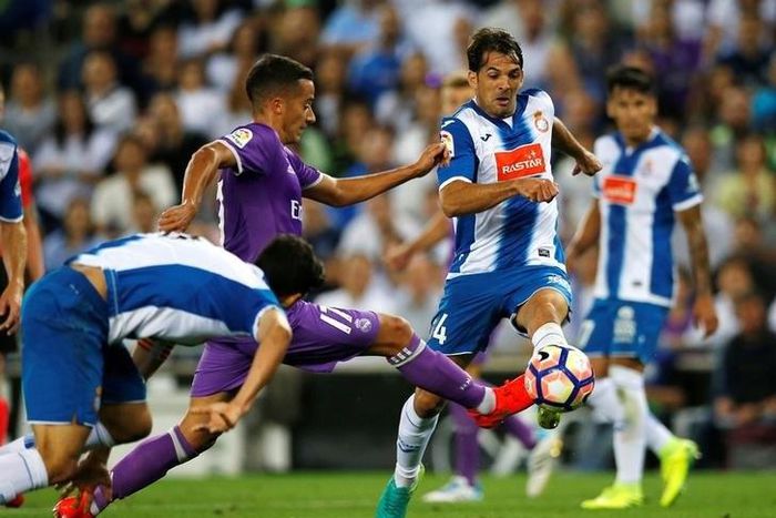 Real Madrid's Lucas Vazquez and Espanyol's Victor Sanchez in action.