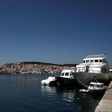 Vessels used by refugees and migrants to cross the Aegean Sea from Turkey are docked as the port city of Mytilene is seen in the background on the Greek island of Lesbos April 15, 2016. REUTERS/Alkis Konstantinidis