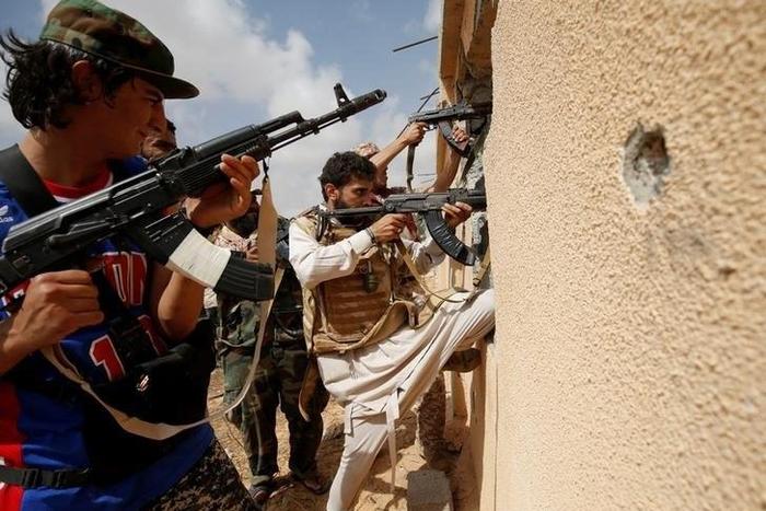 Libyan forces allied with the U.N.-backed government fire weapons during a battle with Islamic State fighters in Sirte, Libya, July 15, 2016.