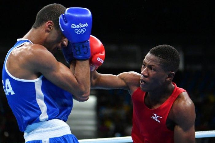 Namibia's Jonas Junias Jonas (R) punches France's Hassan Amzile during the men's light welter match at the Rio Games on August 11, 2016