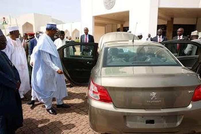 President Buhari inspecting a 'Made-In-Nigeria' Peugeot car