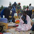 A woman and child sit inside a make-shift camp in Uganda, which borders war-torn South Sudan, on July 16, 2016 