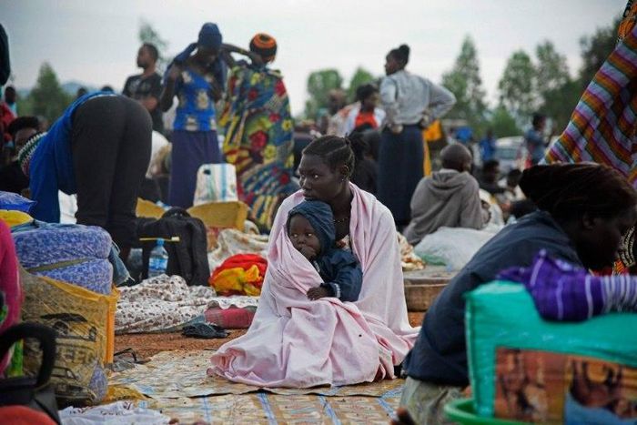 A woman and child sit inside a make-shift camp in Uganda, which borders war-torn South Sudan, on July 16, 2016 