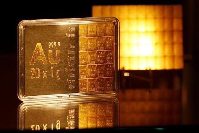 The symbol AU for the chemical element of gold is seen next to one-gram gold bars on display at the annual meeting of German Sparkasse savings banks in Duesseldorf, Germany, April 27, 2016.