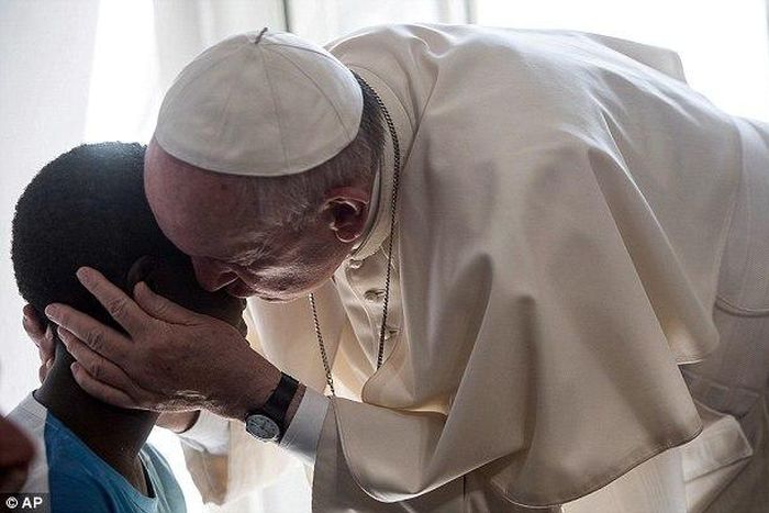 Pope Francis surprised 20 former prostitutes on Friday by knocking on their door in Rome and popping in for a chat. He is pictured here greeting one of the women