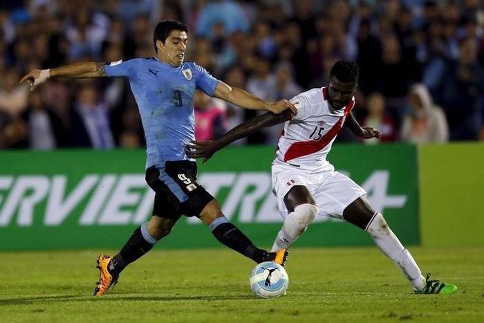 Uruguay's Luis Suarez and Peru's Christian Ramos.